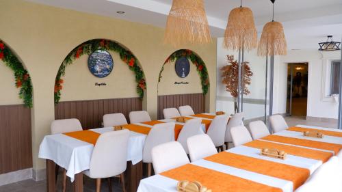 a row of tables and chairs in a room with arches at Hotel Labella Bergama in Bergama