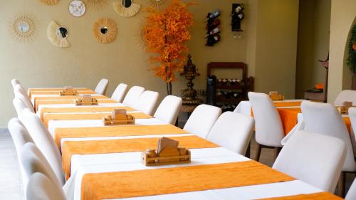 a row of tables in a room with white chairs at Hotel Labella Bergama in Bergama