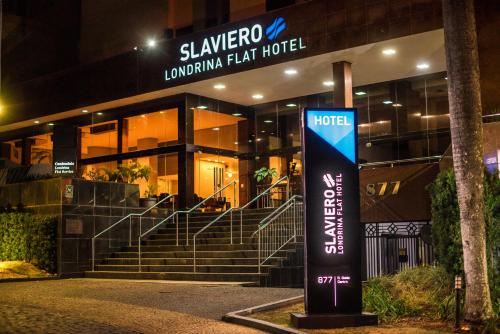 una señal frente a un edificio por la noche en Apto Londrina Flat Hotel jacuzzi 43 m2 en Londrina
