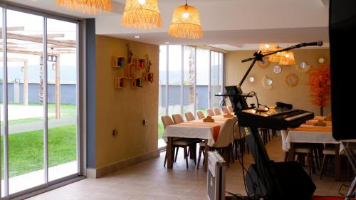 a dining room with a table and chairs and windows at Hotel Labella Bergama in Bergama