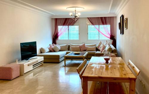 - un salon avec un canapé et une table dans l'établissement Hayriad : Charmant 3 Chambres . Wifi, Smart TV, à Rabat