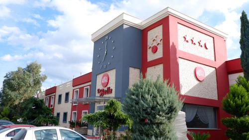 a building with red white and blue at Hotel Labella Bergama in Bergama
