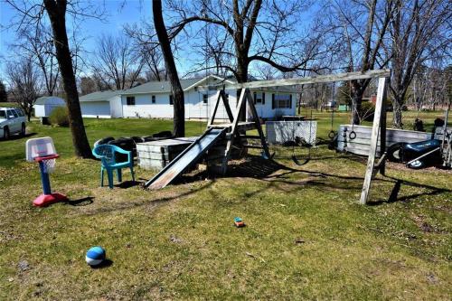 a playground with a slide in a yard at Remodeled, Grill, Outside Seating, Dock, Swimming in Brainerd