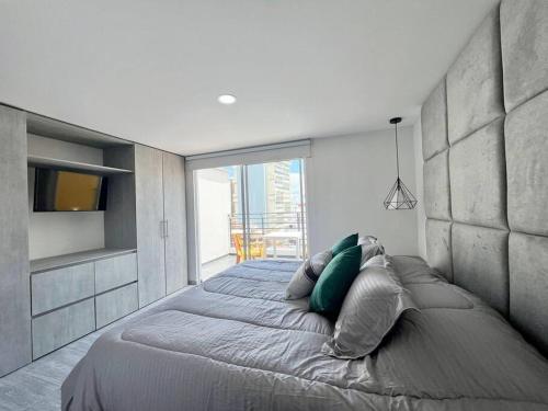 Ένα ή περισσότερα κρεβάτια σε δωμάτιο στο Apartastudio loft en Bucaramanga