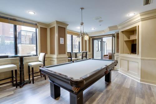 a pool table in a room with a bar at Quiet Condo in the Heart of Ballston in Arlington