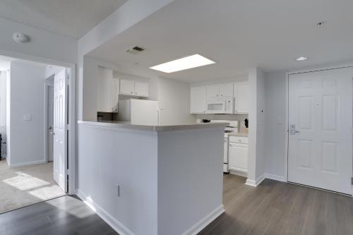 an open kitchen with white cabinets and a counter top at Quiet Condo in the Heart of Ballston in Arlington