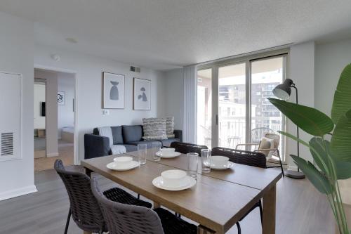 a living room with a wooden table and chairs at Quiet Condo in the Heart of Ballston in Arlington