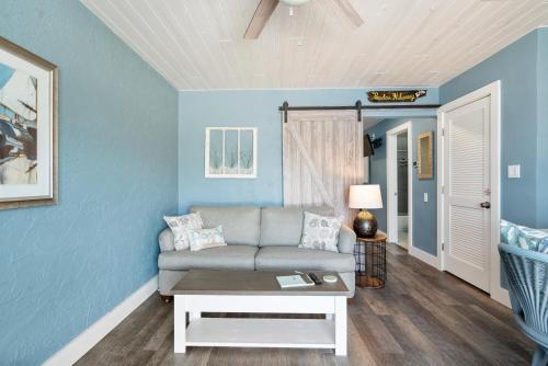 a living room with a couch and a table at Seashells Getaway - Boat Slip, Ramp, Pool in Marathon