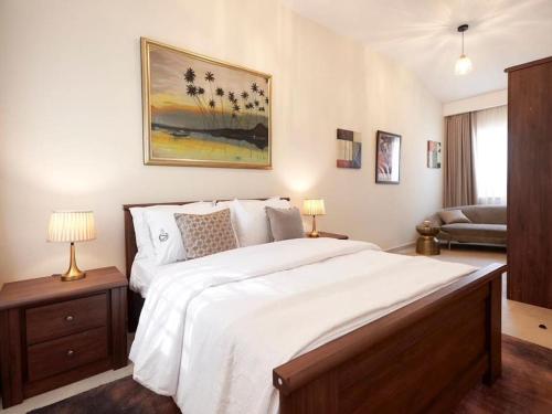 a bedroom with a large bed with white sheets at Stylish 2 Bedroom in Osu in Accra