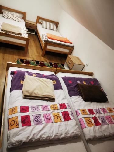 a room with two beds and a bed with pillows at Markov konak in Jahorina