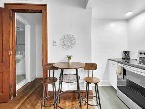 a kitchen with a small table and two stools at Walk to 3 Breweries! 1 Bed Apartment on Grand in Des Moines
