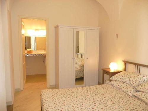 a bedroom with a bed and a bathroom with a mirror at Casa Della Lavanda in Santo Stefano al Mare