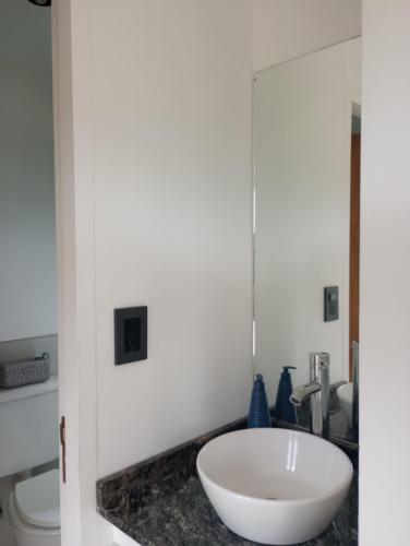 a bathroom with a white sink and a toilet at Punto Alma Home box in San Rafael