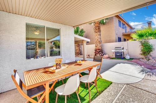 a patio with a wooden table and chairs at Seven Palms in Henderson