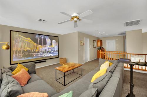 a living room with a couch and a flat screen tv at Seven Palms in Henderson
