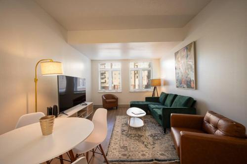a living room with a couch and a table at Uptown Charlotte Style in Charlotte