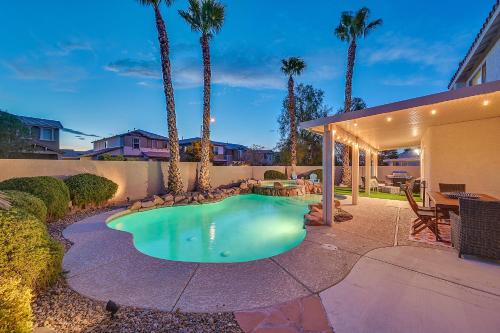 a swimming pool in a backyard with palm trees at Seven Palms in Henderson