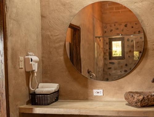 a bathroom with a mirror and a sink at Privada y comoda cabaña, Casa Margarita, Villavieja in Villavieja