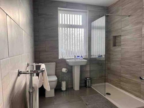 a bathroom with a sink and a toilet and a shower at Anfield Home Sleeps 5 Close to LFC free parking in Liverpool