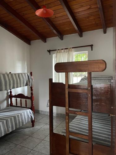 a bedroom with two bunk beds and a window at PULAKI Cabañas en Animana in Animaná