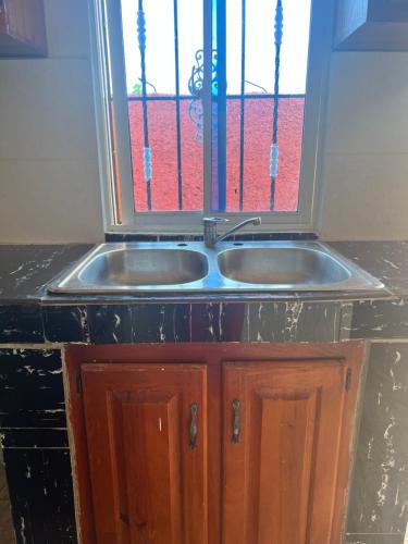 a kitchen sink with a window above it at Residencial Peralta in Pedernales