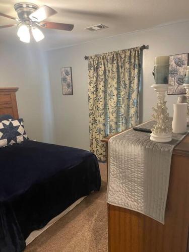 a bedroom with a bed and a table with a lamp at Spacious Home Near Shaw in Sumter