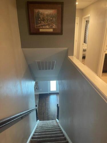 a stairway with a painting on the wall at Spacious Home Near Shaw in Sumter