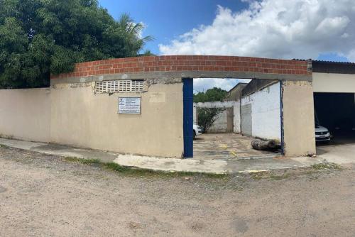 an old brick building with a blue doorway at Seu lar Fora de Casa! in Juazeiro do Norte