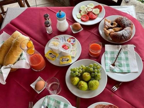 a table with plates of food on a red table cloth at Agriturismo Orrido di Pino in Agerola