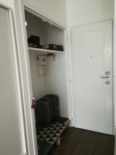 a walk in closet with a door and luggage at studio rdc bois de vincennes in Saint-Mandé