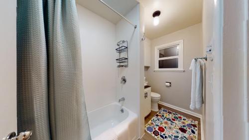 a white bathroom with a shower and a toilet at Emily's Escape AC Smart TV and Covered Parking in Snohomish