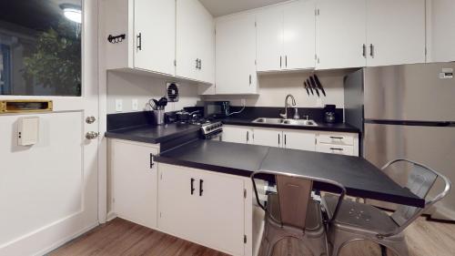a kitchen with white cabinets and a black counter top at Emily's Escape AC Smart TV and Covered Parking in Snohomish