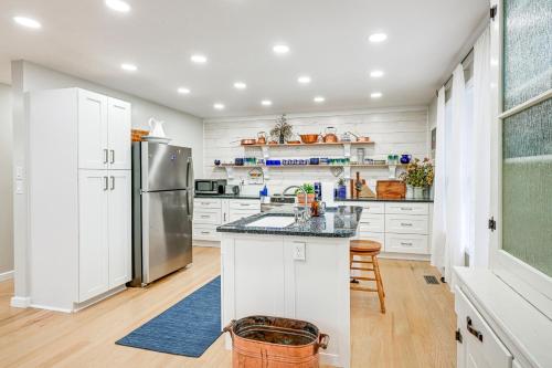 a kitchen with white cabinets and a stainless steel refrigerator at Quiet Shepherd Home Near CMU Campus! in Shepherd