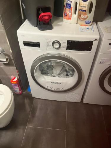 a washing machine in a bathroom with a toilet at Beautiful apartment for you in Ulm