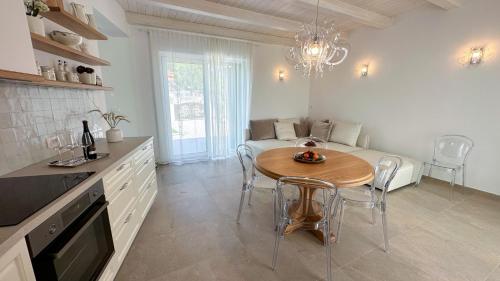 a kitchen with a table and a dining room at Ca' S Lorenz - A Luxury 100m2 Apartment in a Chic Vineyard Villa in Dobrovo