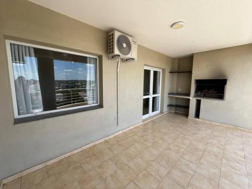 a living room with a large window and a television at Hermoso depto, inmejorable zona! in Santa Rosa