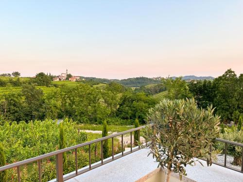 a balcony with a view of a castle in the distance at Ca' S Lorenz - A Luxury 100m2 Apartment in a Chic Vineyard Villa in Dobrovo