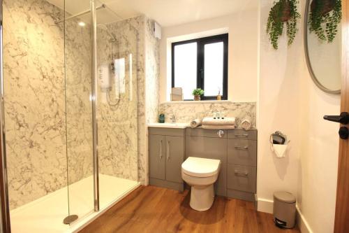 a bathroom with a shower and a toilet and a sink at The Coastal Retreat (Nr Brighton) in Peacehaven