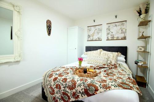 a bedroom with a bed with a bowl on it at The Coastal Retreat (Nr Brighton) in Peacehaven