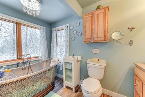 a bathroom with a tub and a toilet and a sink at Spacious Kenai Vacation Rental with Lake Access! in Kenai