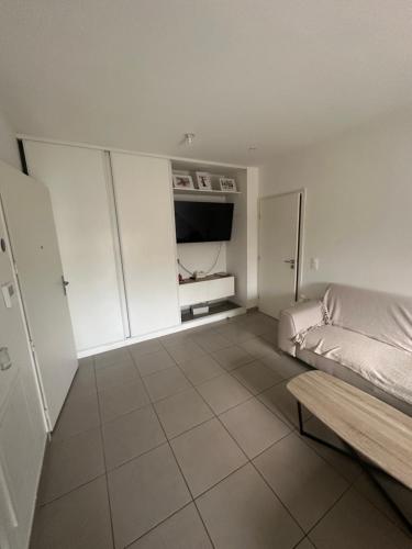 a white room with a bed and a couch at Appartement stade de france in Saint-Denis