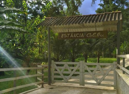 a sign for the entrance to the sultanica colica garden at Estância Colibri in Paraty