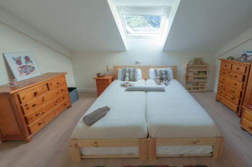 a bedroom with a large bed and wooden furniture at El Ventanal de Collarada in Villanúa
