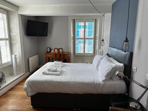 Castle Hotel في أبيريرون: غرفة نوم عليها سرير وفوط