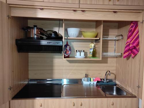 a kitchen with a sink and a stove at Presolana House in Castione della Presolana