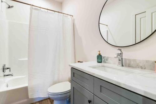 a white bathroom with a sink and a mirror at Pelican house*King bed*Fast WiFi*Book now in Lafayette