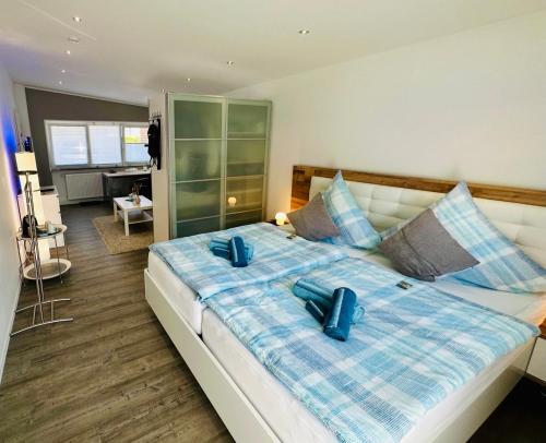 sypialnia z dużym łóżkiem z niebieskimi poduszkami w obiekcie Auszeit Apartment Düsseldorf w mieście Düsseldorf