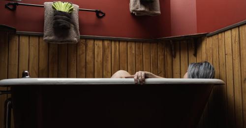 a woman is sitting in a bath tub at Mistiso's Place Vacation Rentals in Nelson