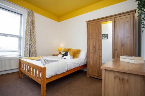a bedroom with a bed and a wooden cabinet at The Elswick in Elswick