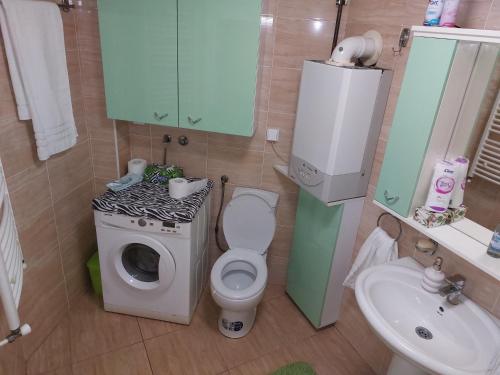 a small bathroom with a toilet and a sink at Cozy land in Šabac